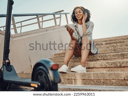 Black woman outdoor, smartphone and headphones with scooter, music and travel with 5g network for audio streaming in city. Sustainable transportation, listen to audio or podcast and relax on steps