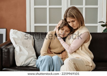 Mother supporting her child in difficult situation Royalty-Free Stock Photo #2259969101