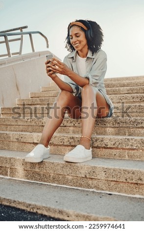 Black woman outdoor, smartphone and headphones for music, travel and 5g network for audio streaming in city. Happy person in Miami, listen to radio or podcast, relax on steps with internet and urban