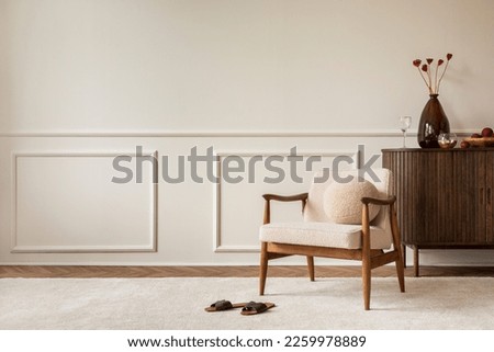 Aesthetic composition of living room interior with copy space, boucle armchair, vase with dried flowers, round pillow, wooden sideboard, beige rug and personal accessories. Home decor. Template. Royalty-Free Stock Photo #2259978889