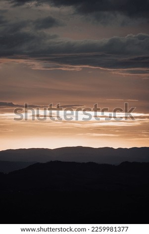 A vertical shot of the golden hour and the silhouette of mountains in Durmitor, Montenegro