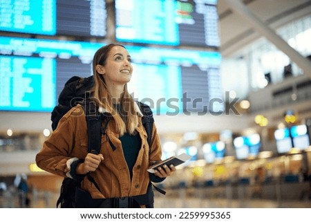 Travel, airport and excited woman with passport. travel ticket and documents for immigration, journey and flight schedule. Backpack person with identity document search for international registration Royalty-Free Stock Photo #2259995365