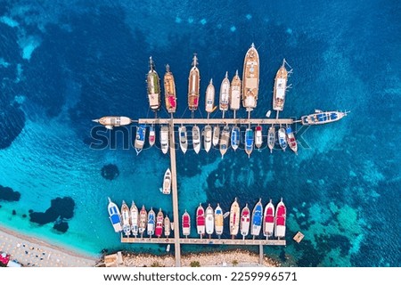 Boat pier aerial top view. Drone photo of yachts and sailboats moored in marina on sea lagoon 