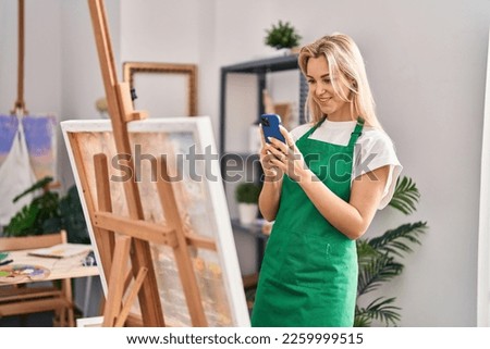 Young blonde woman artist make picture to draw at art studio