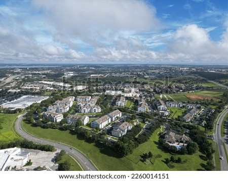 A bird's eye view of the cityscape of Clermont, Florida under a cloudy blue sky Royalty-Free Stock Photo #2260014151