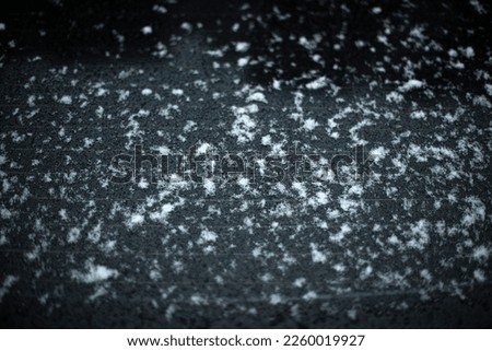Snow by car. Wet machine surface. Transport details. Large flakes of snow on metal. Royalty-Free Stock Photo #2260019927