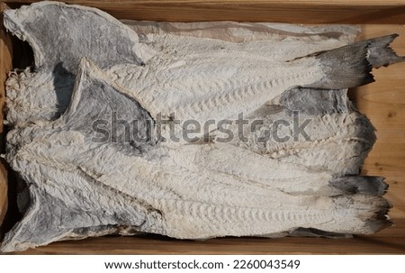 A close-up of many dried and salted cod fish, from which a Portuguese culinary specialty is prepared ( Bacalhau )