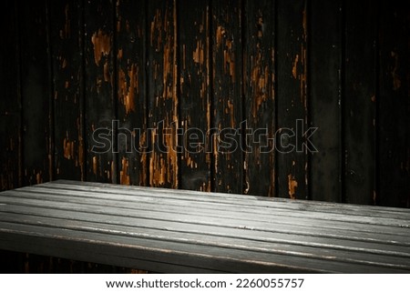 dark background. Empty workplace, in front of a package of abstracts. empty table