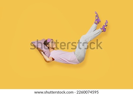 Full body side view young woman she wears purple pyjamas jam sleep eye mask rest relax at home fly up hover over air fall down on pillow isolated on plain yellow background studio. Night nap concept Royalty-Free Stock Photo #2260074595
