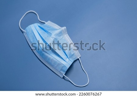 Medical three-layer mask on a blue background.