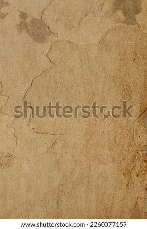 Yellowish wall background with peeling stone. Royalty-Free Stock Photo #2260077157