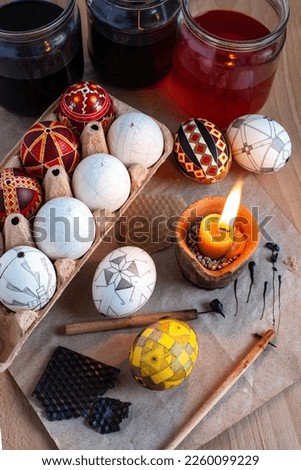 traditional creation of Ukrainian Easter eggs with wax, dyes, and a pen Royalty-Free Stock Photo #2260099229