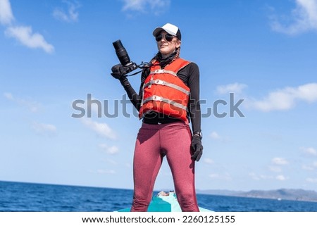 Marine biologist standing while working in a boat in the middle of the sea Royalty-Free Stock Photo #2260125155
