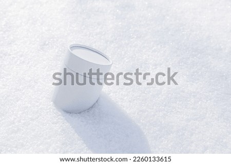 white round jars in the snow. High quality photo