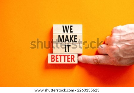 We make it better symbol. Concept words We make it better on wooden blocks. Beautiful orange table orange background. Businessman hand. Business we make it better concept. Copy space.
