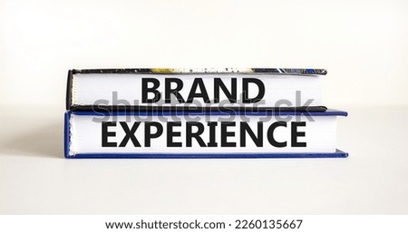 Brand experience symbol. Concept words Brand experience on books. Beautiful white table white background. Business branding and brand experience concept. Copy space.