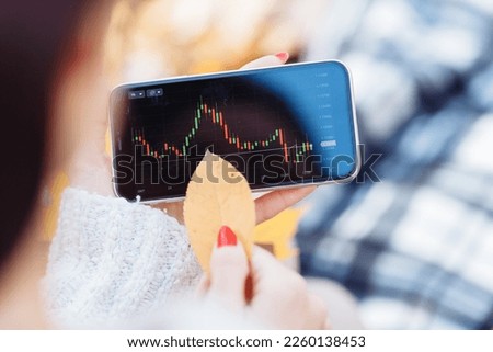 graph on the stock exchange in red and green colors on the phone. photographed with an old lens with blur around the edges. High quality photo. 