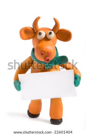 orange bull (symbol of 2009) made with plasticine with blank card in hands