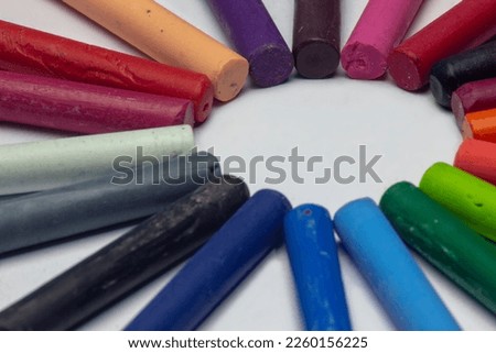 circular arrangement of colorful oil pastels