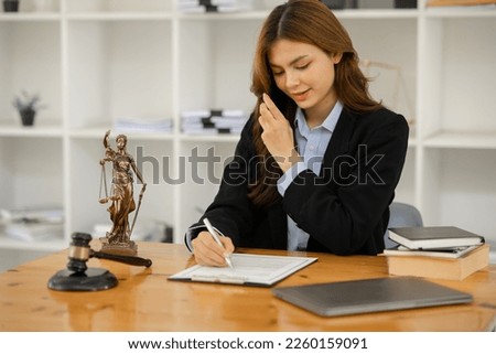 Female lawyer working at client's office discussing documents