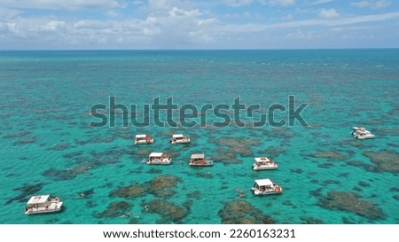 Wonderful panoramic view of Maracajau coral reefs with several tourism boats floating on turquoise waters near the city of Natal, Rio Grande do Norte, Brazil Royalty-Free Stock Photo #2260163231