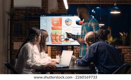 African american employee giving analytics report presentation in business meeting, showing statistics data on digital board screen. Office worker marketing research, strategy planning Royalty-Free Stock Photo #2260169733