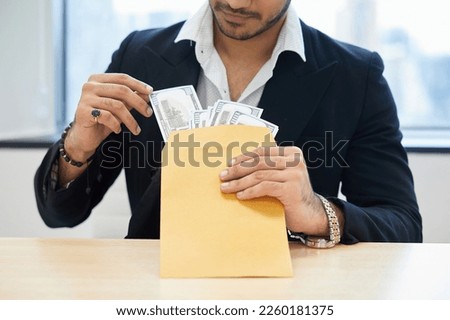close up the man counting money from envelope on the table