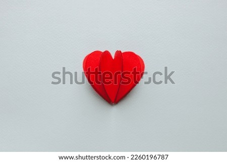 Handmade paper cutout heart for valentine's day on blue background for your offer. 