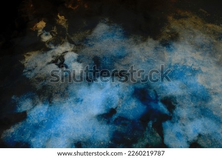 Abstract photo of a glowing water surface with dark blue neon light reflecting off the movement of waves and shadows. Background. Natural textures.