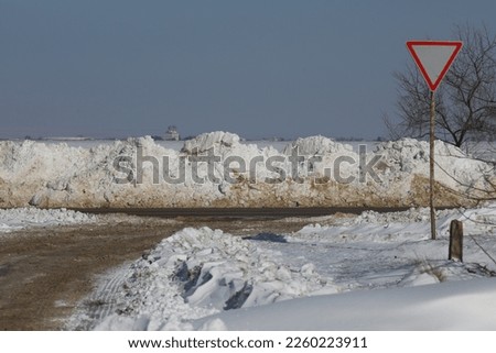 Mirny settlement (Crimea, Crimean peninsula) 02.10.2023. Snow covered road in winter after heavy snowfall.