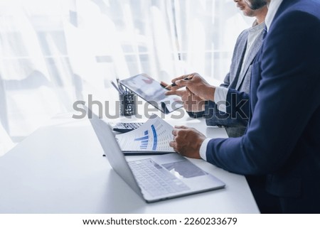 Using tablet pc, Consultant between bookkeepers and accounting lawyer consultation about asset, balance sheet, stock market statistics and yearly tax law, protect business from bribery. Royalty-Free Stock Photo #2260233679
