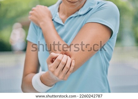 Sports, woman and injury with elbow, pain and muscle strain while training, workout and outdoor fitness. Female, lady and athlete with emergency for arm, inflammation and broken bone while on court Royalty-Free Stock Photo #2260242787