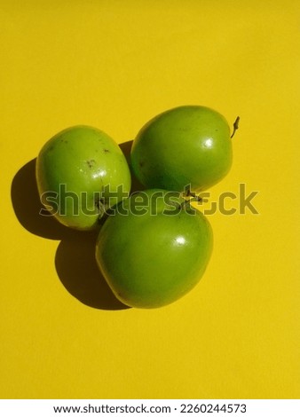Ziziphus mauritiana, also known as Indian jujube, Indian plum, Chinese date,Chinee apple in yellow background.