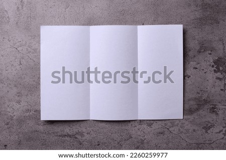 Blank opened tri fold flyer brochure on gray background as template for design presentation, showcase, etc.