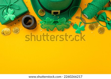 Top view photo of leprechaun headwear giftbox clover shaped party glasses spool of twine bow-tie pot with gold coins trefoils horseshoe and sprinkles on isolated yellow background with copyspace