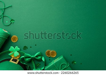 St Patrick's Day concept. Top view photo of leprechaun headwear giftbox with bow spool of twine gold coins bow-tie shamrock and trefoil shaped confetti on isolated green background with copyspace