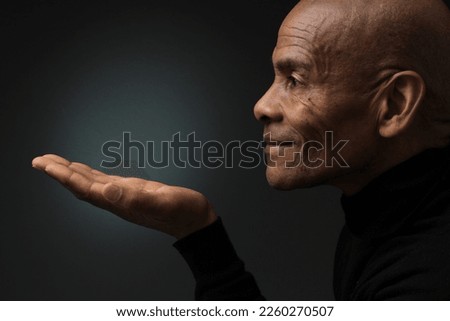man pointing his finger with dark background with people stock photo