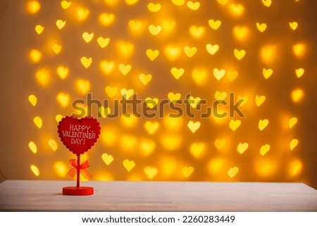 The inscription Valentine's day on a blurred background of hearts close-up