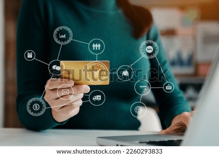 Woman using smart phone for mobile payments online shopping,omni channel,sitting on table,virtual icons graphics interface screen 
