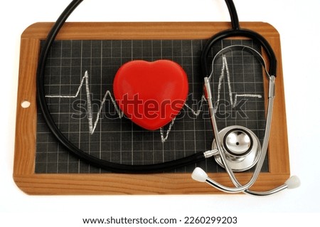 Heart health concept with a stethoscope and a heart on a school slate Royalty-Free Stock Photo #2260299203