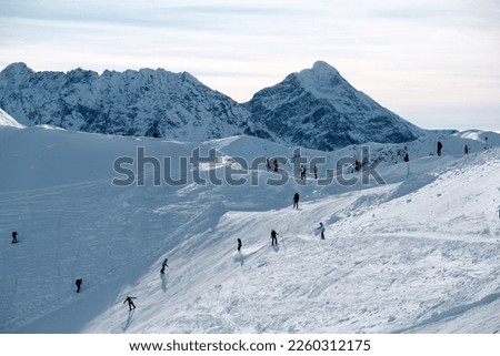 Beautiful winter scenery of Kasprowy Wierch Peak in Tatras Mountains, famous place in Tatras with cable railway. Poland. Tatra National Park. A lot of people on slope.
