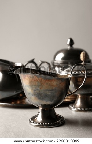 Beautiful tea set on grey textured table, closeup