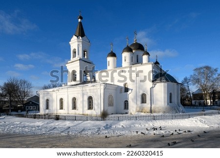 City Tver landscape view at cold sunny winter day, white snow and ice, Life-Giving Trinity or White Trinity church, bell tower and birds near. Winter city Tver travel or tourism concept. Tver, Russia