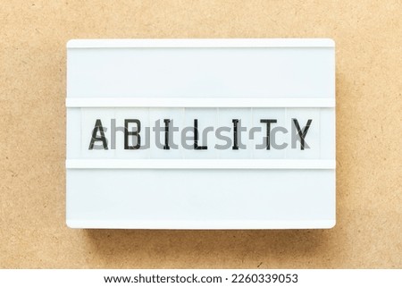 Lightbox with word ability on wood background