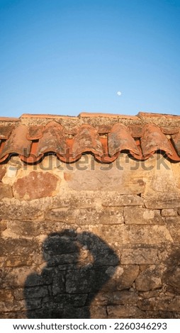 Photographer shadow  in wall and moon