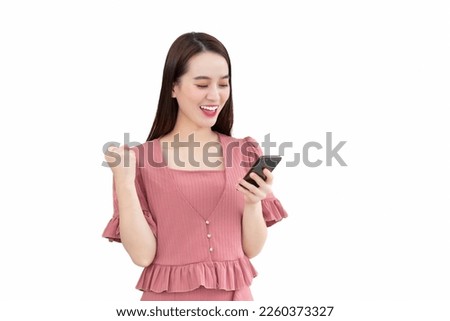 Professional Asian business woman in pink dress standing confidently smiling holds smartphone in her hand isolated on white background. Financial choice concept.
