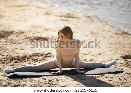 beautiful young woman with a slim figure is doing yoga