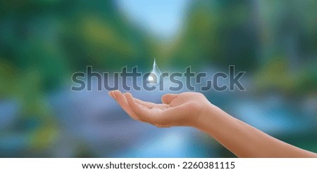 Hands holding water drop, world water day,clean water,save water, clean renewable energy concept. Royalty-Free Stock Photo #2260381115