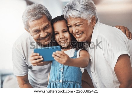 Love, happy and girl taking selfie with her grandparents for social media in modern family home. Happiness, smile and excited child taking picture with grandmother and grandfather at house in Mexico.
