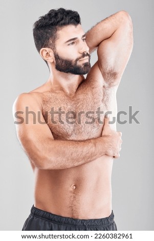 Beauty, body and underarm with a man model in studio on a gray background for health or wellness. Skin, chest and muscle with a handsome young male standing indoor to promote a health lifestyle Royalty-Free Stock Photo #2260382961